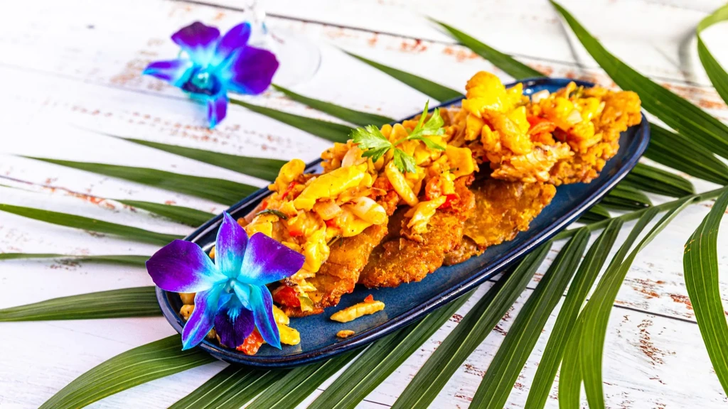 Fritters with colorful diced topping, garnished with herbs and orchids.