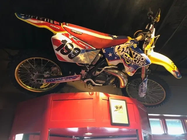 Nitro Circus #199 motocross bike with American flag design on display.