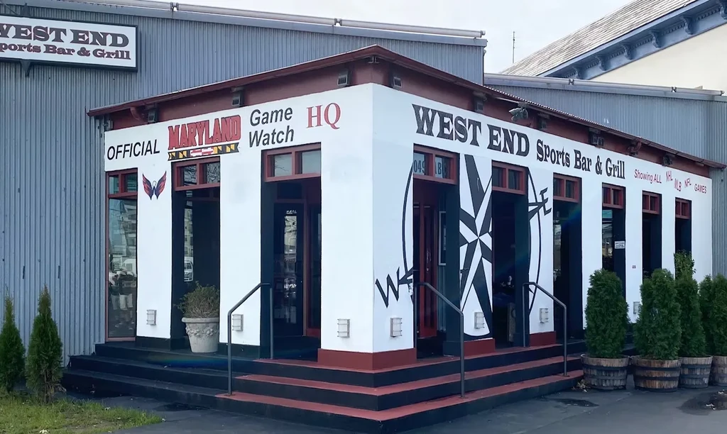 WEST END Sports Bar & Grill exterior, modern building with sports signage.