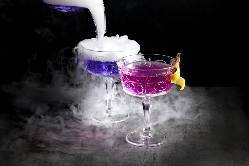 Purple cocktail being poured, magenta cocktail with lemon, dramatic smoke.