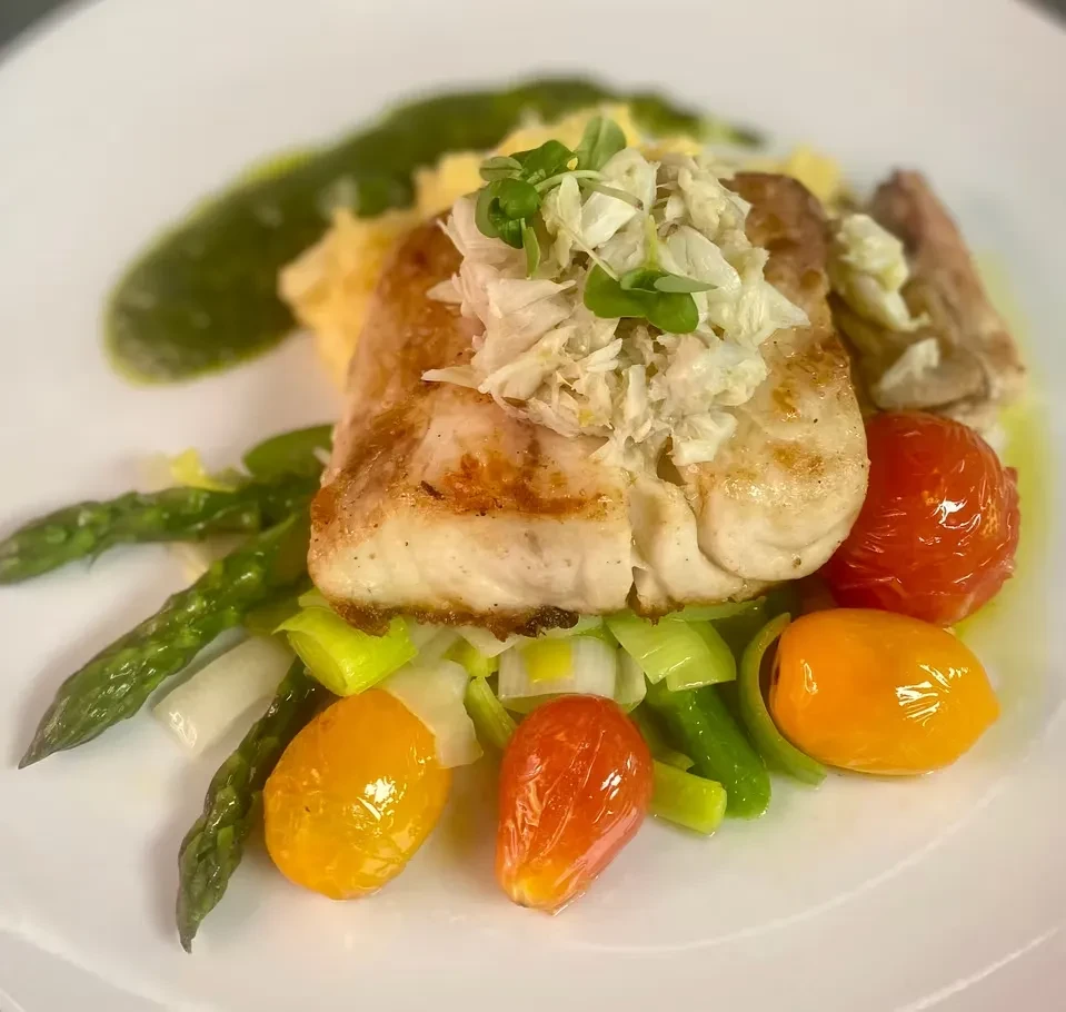 Pan-seared white fish, crab, asparagus, tomatoes, and mashed potatoes.