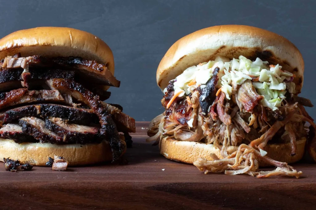 Two barbecue sandwiches: sliced brisket and pulled pork with coleslaw.