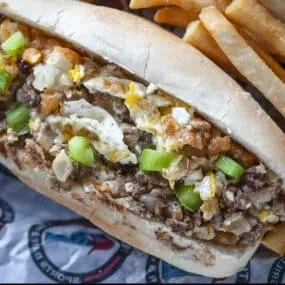 Cheesesteak-style sandwich and fries on a Brooklyn wrapper.