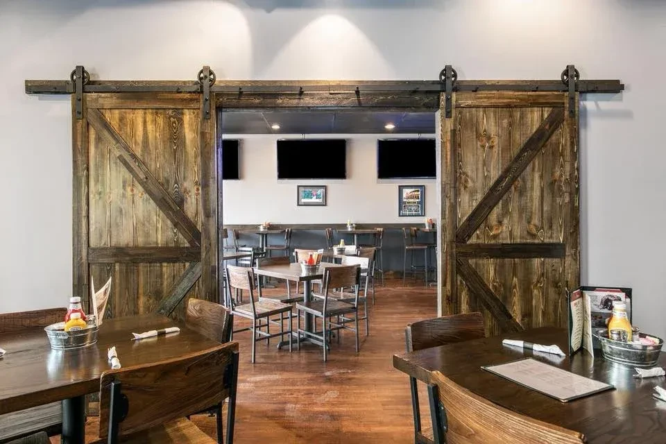 Rustic wooden barn doors in a clean, casual restaurant interior.