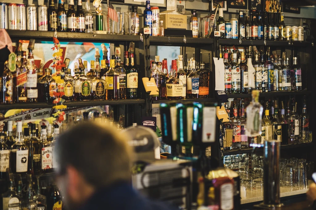 Well-stocked liquor and beer shelves inside Fenton Bar & Grill.