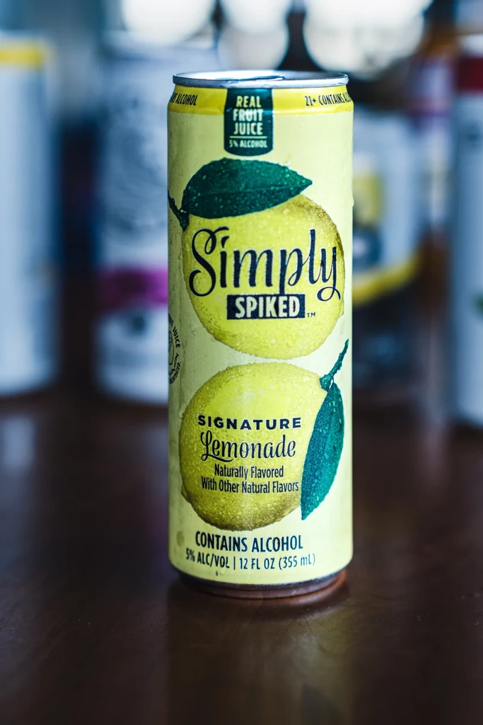 Chilled, pale yellow Simply Spiked Signature Lemonade can with condensation.
