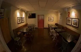 Empty restaurant dining room with wide-angle distortion and red numbers.