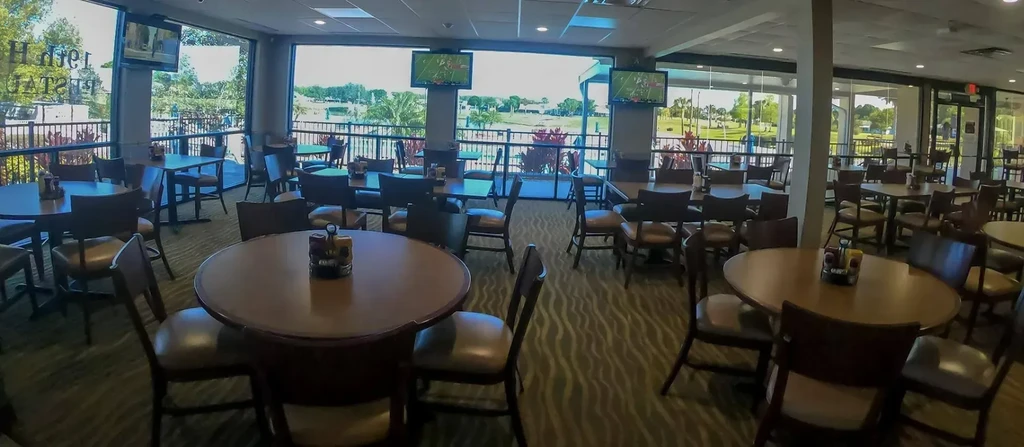 Hilltop Restaurant interior overlooking a golf course and lake.