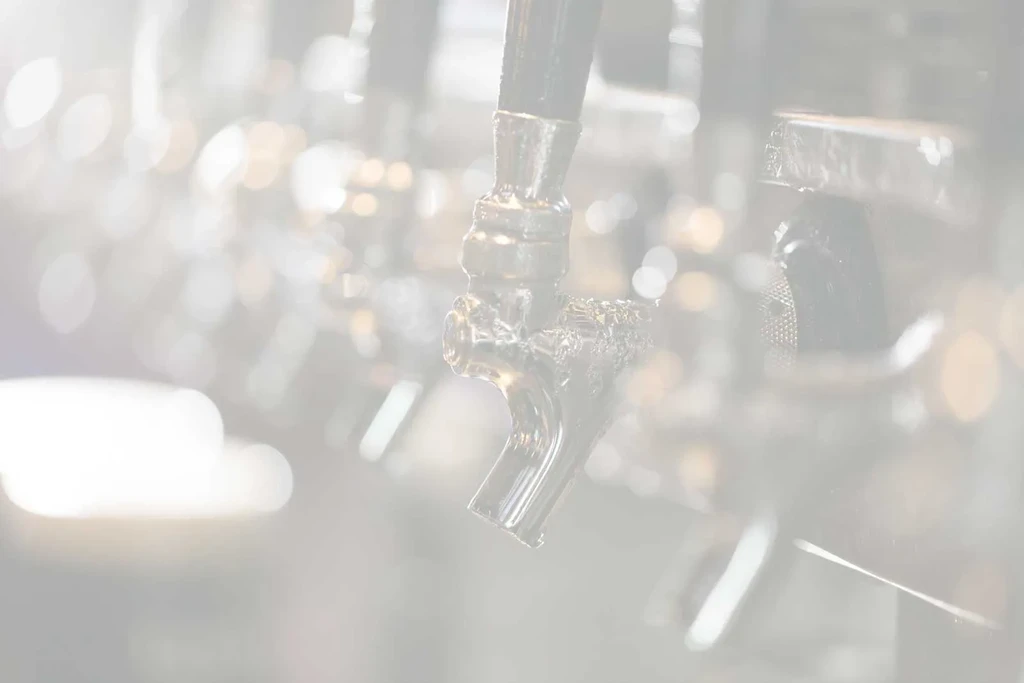 Polished chrome beer tap spigot with visible condensation.