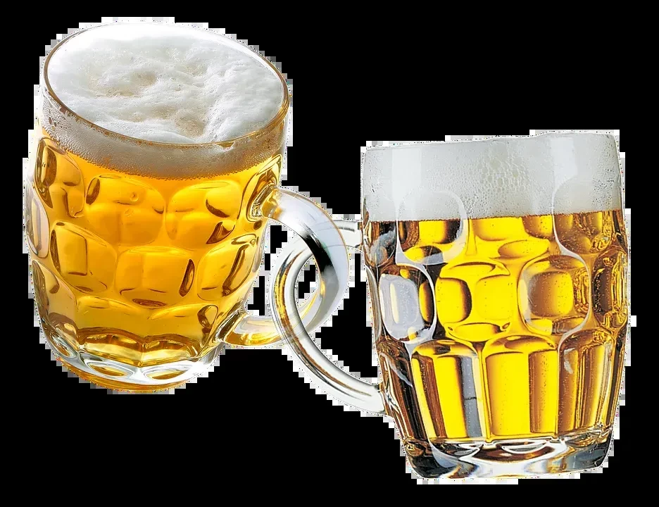 Two dimpled beer mugs with golden beer and frothy white heads.
