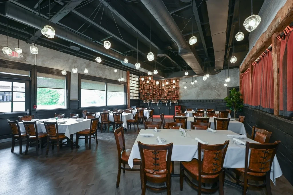 Empty, well-appointed restaurant with modern industrial and rustic design.