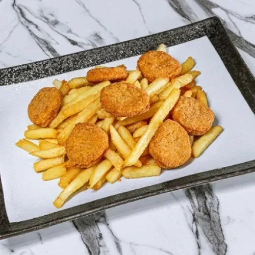Golden chicken nuggets and crispy french fries on a white plate.