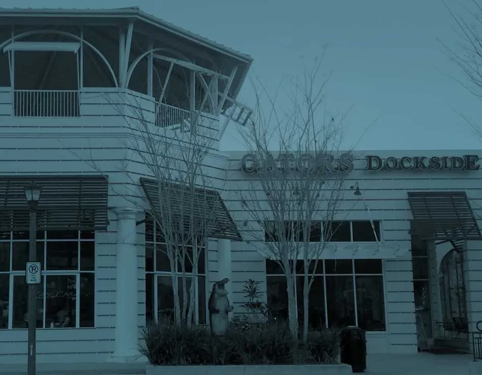 Gators Dockside restaurant exterior with a dominant deep blue tint.