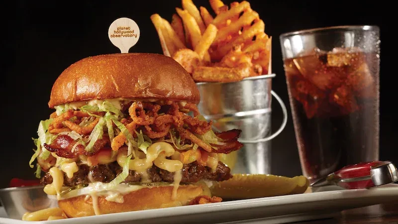 Planet Hollywood burger with mac and cheese, fries, and soda.
