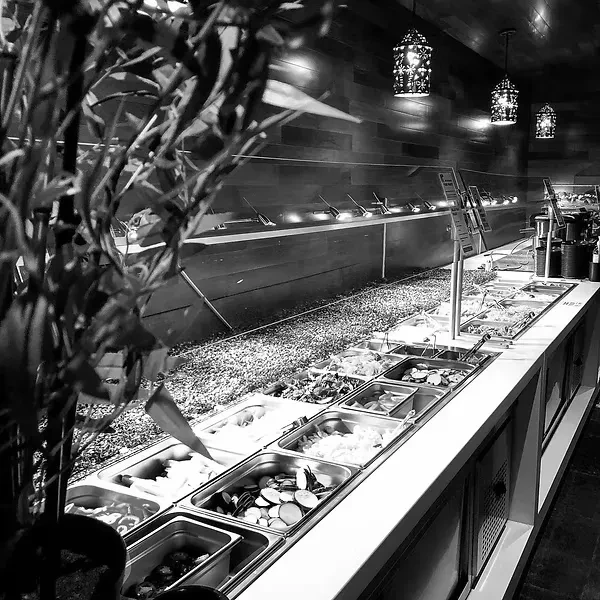 Black and white, modern Asian-inspired self-serve restaurant food bar.