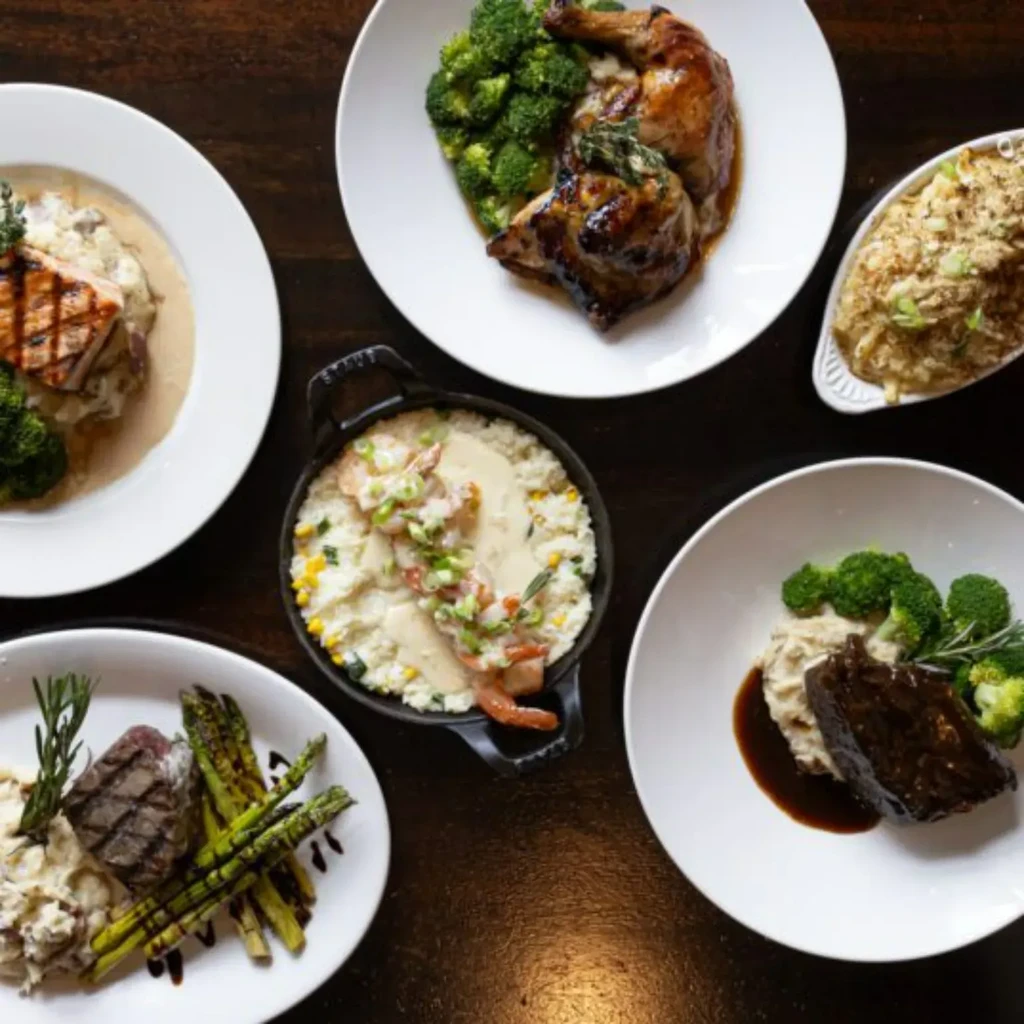An overhead view of five distinct, professionally prepared restaurant dishes.