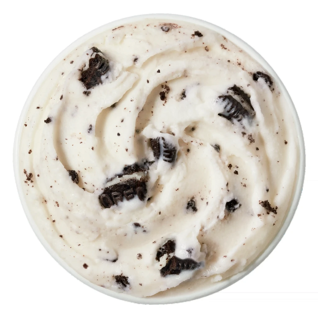 Scoop of cookies and cream ice cream in a white bowl.