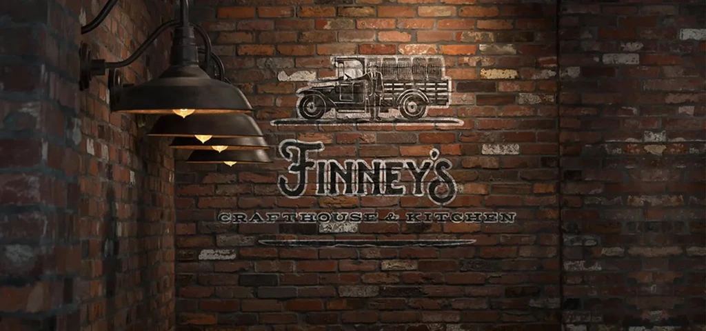 Textured brick wall, vintage lights, Finney's Crafthouse & Kitchen sign.