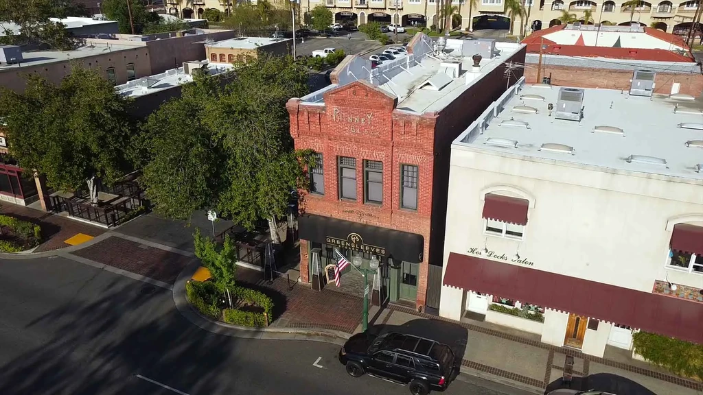 Aerial view of Phinney Block, Greensleeves Tavern, and Her Locks Salon.
