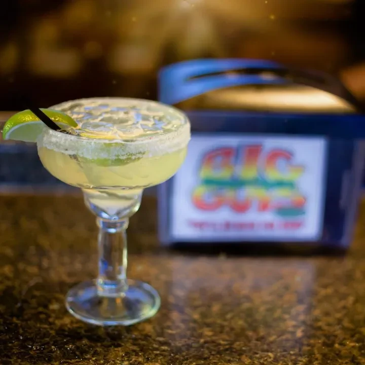 Salted margarita with lime, crushed ice, and straw.