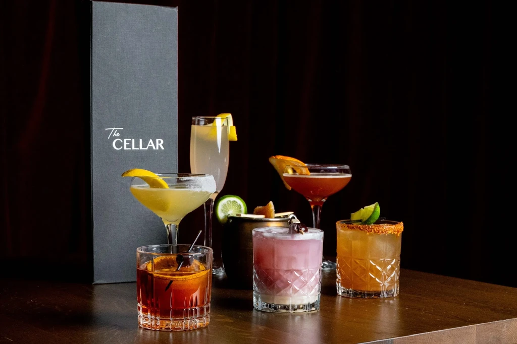 Six distinct cocktails in various glasses from The CELLAR.
