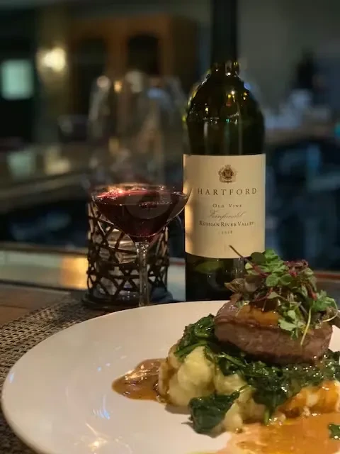 Finely plated steak, mashed potatoes, vegetables, and Hartford Zinfandel wine.