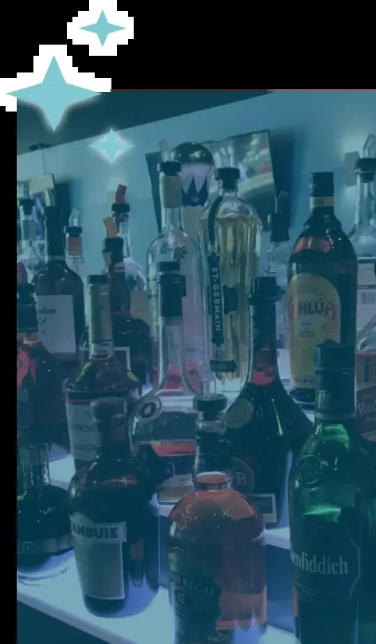 Blue-lit bar shelf filled with various liquor bottles and digital sparkles.