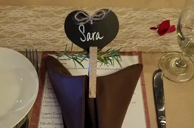 Elegant 'Sara' place setting with rosemary sprigs and a rehearsal dinner menu.