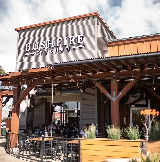 BUSHFIRE KITCHEN restaurant: modern industrial exterior with a lively patio.