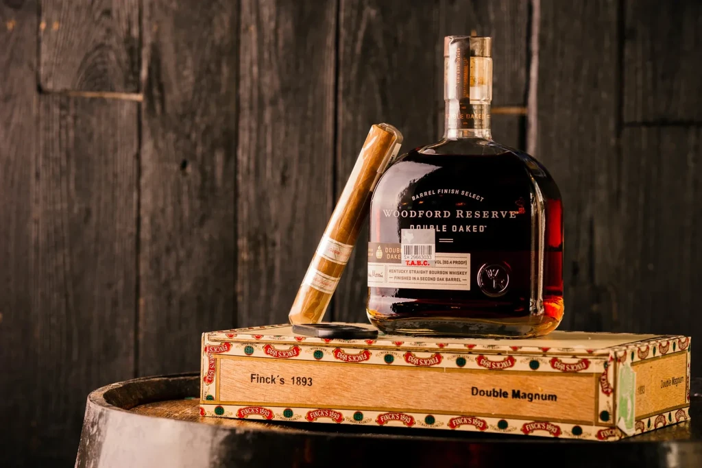 Woodford Reserve bourbon and unlit cigar on Finck's cigar box.