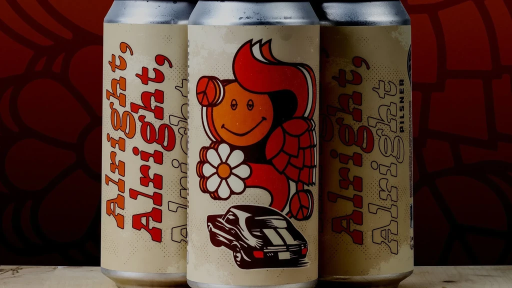 Close-up of three cold retro beer cans with cartoon character labels.