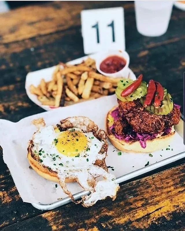 Overhead view of open-faced egg and chicken buns with fries, table 11.