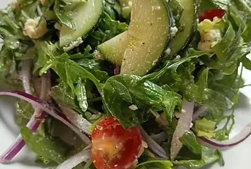 Fresh salad with greens, cherry tomatoes, feta, cucumber, red onions.