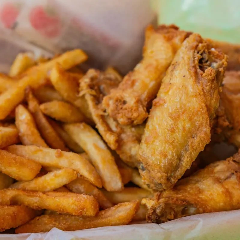 Crispy golden-brown fried chicken wings and thick-cut french fries.