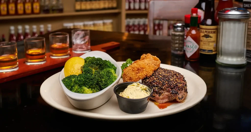 Pepper-crusted steak, fried food, broccoli, and a whiskey flight.