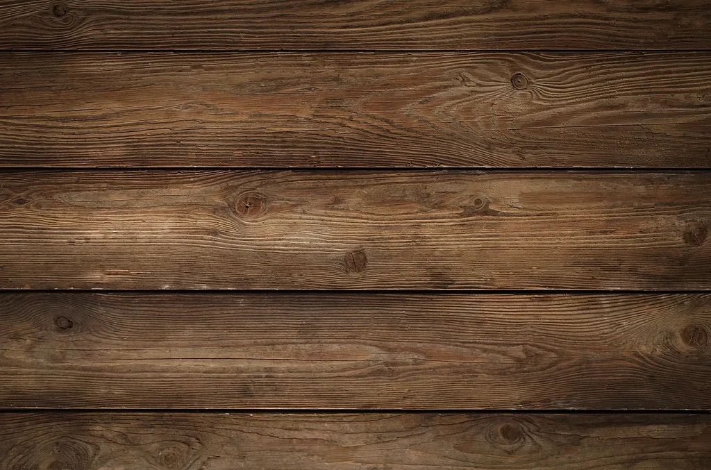 Rustic medium-brown wooden surface with horizontal planks and grain.