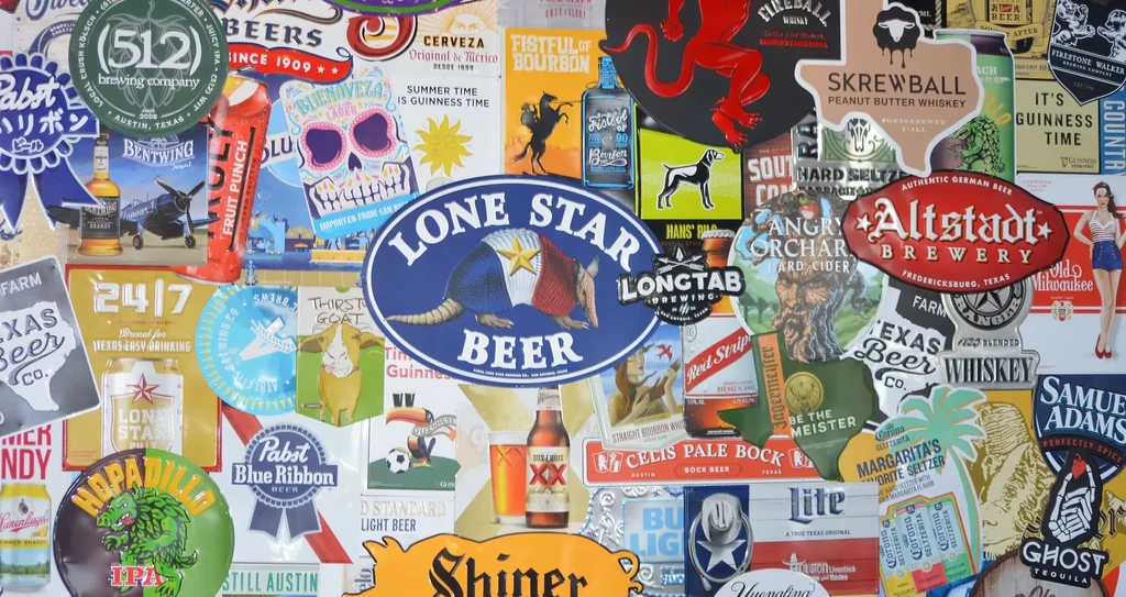 Dense wall collage of various beer, liquor, and seltzer labels.