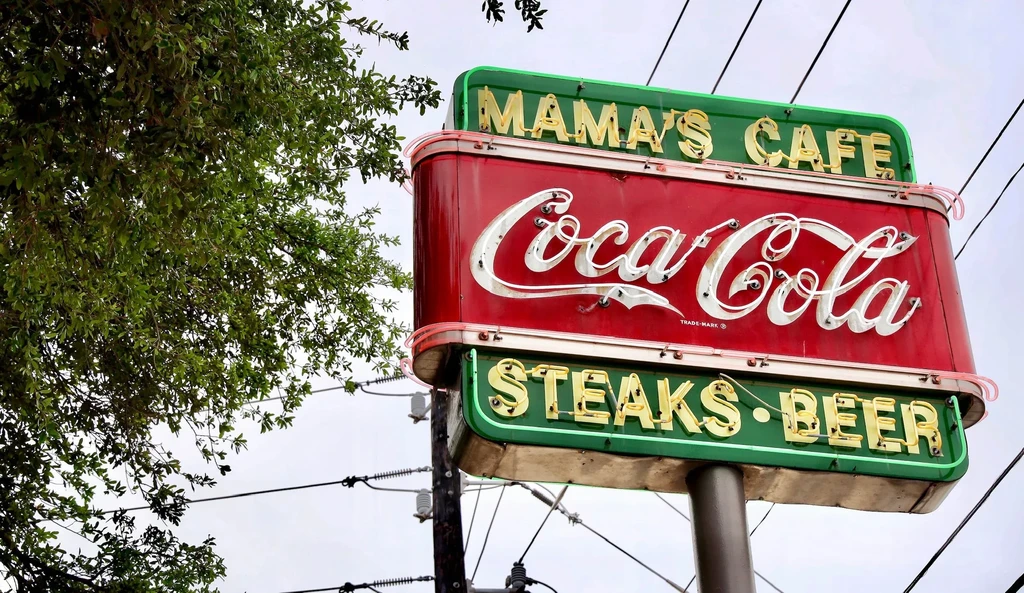 Illuminated retro neon sign for Mama's Cafe, Coca-Cola, Steaks Beer.
