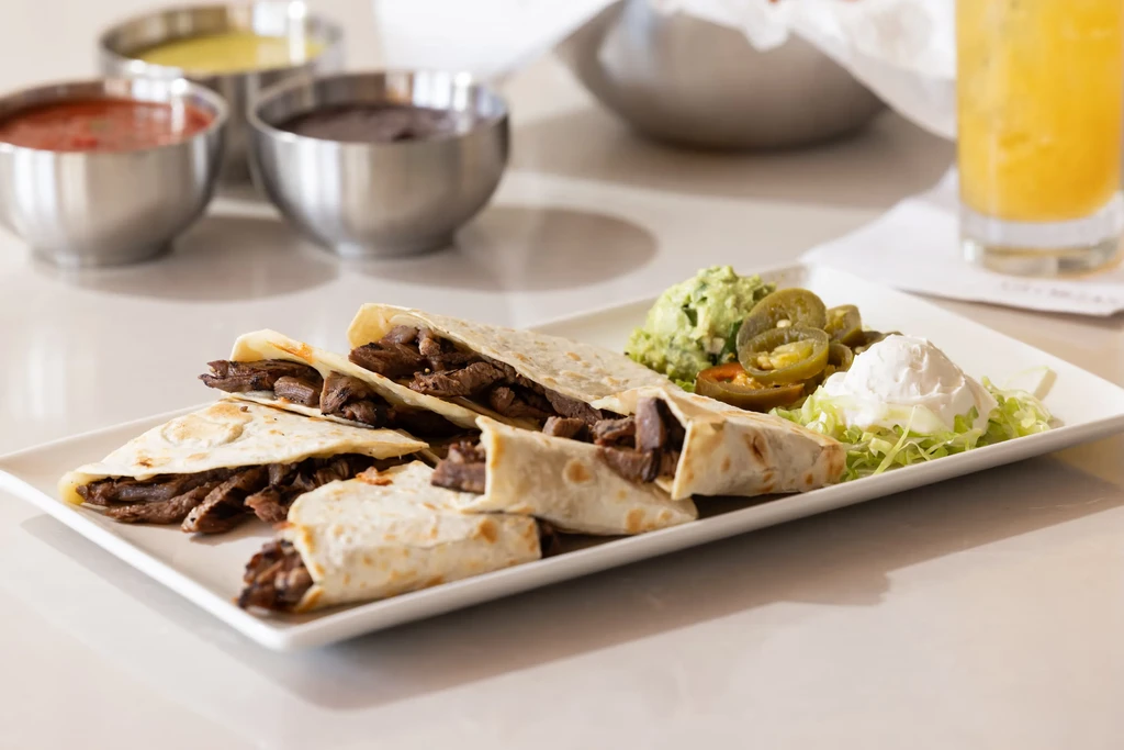 Steak quesadillas, guacamole, pickled jalapeños, sour cream, and assorted sauces.