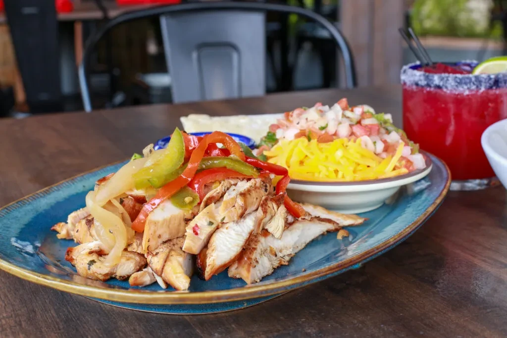 Chicken fajitas, cheese, pico de gallo, and a salt-rimmed margarita.