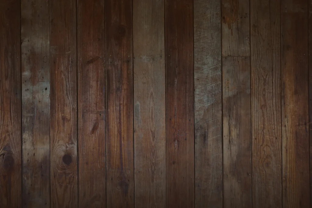 Close-up of aged rustic brown wooden planks with grain and wear.