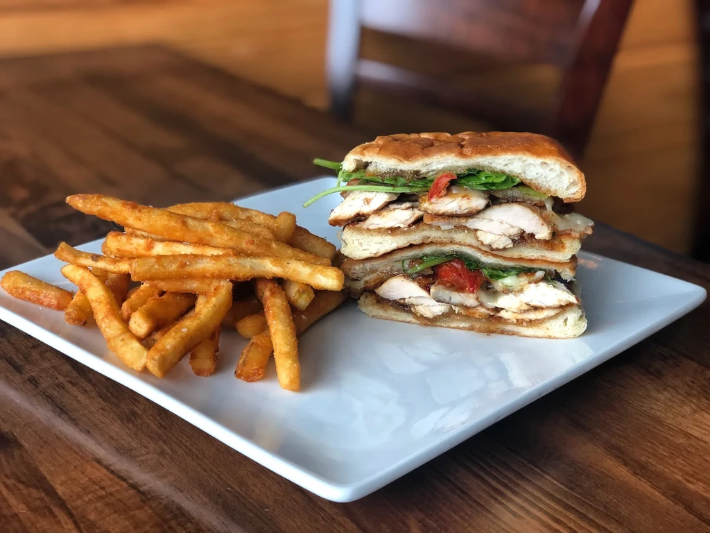 Large toasted chicken sandwich with seasoned french fries.