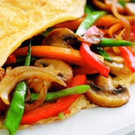 Close-up of a wrap filled with stir-fried mushrooms and vegetables.