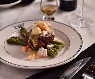 Beef and lobster with asparagus, sauce, on Double Cut plate.