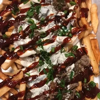 Golden fries loaded with shredded meat, white and BBQ sauce, green onions.