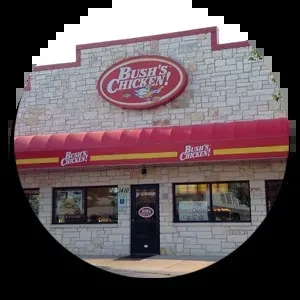 Bush's Chicken! restaurant exterior showing stone, red awning, and logo.