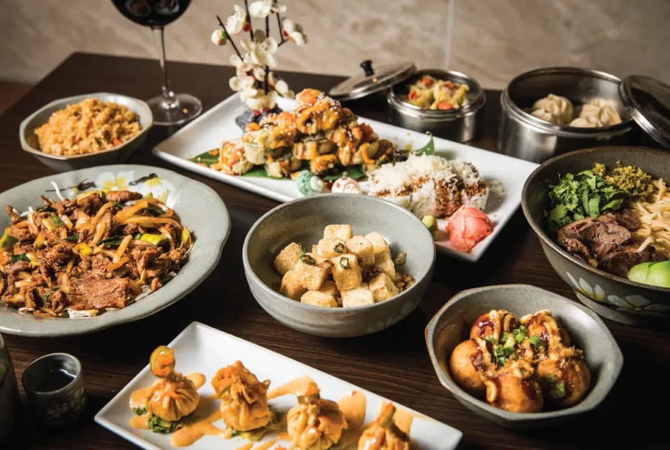 Diverse Asian dishes including sushi, noodles, rice, and dim sum.