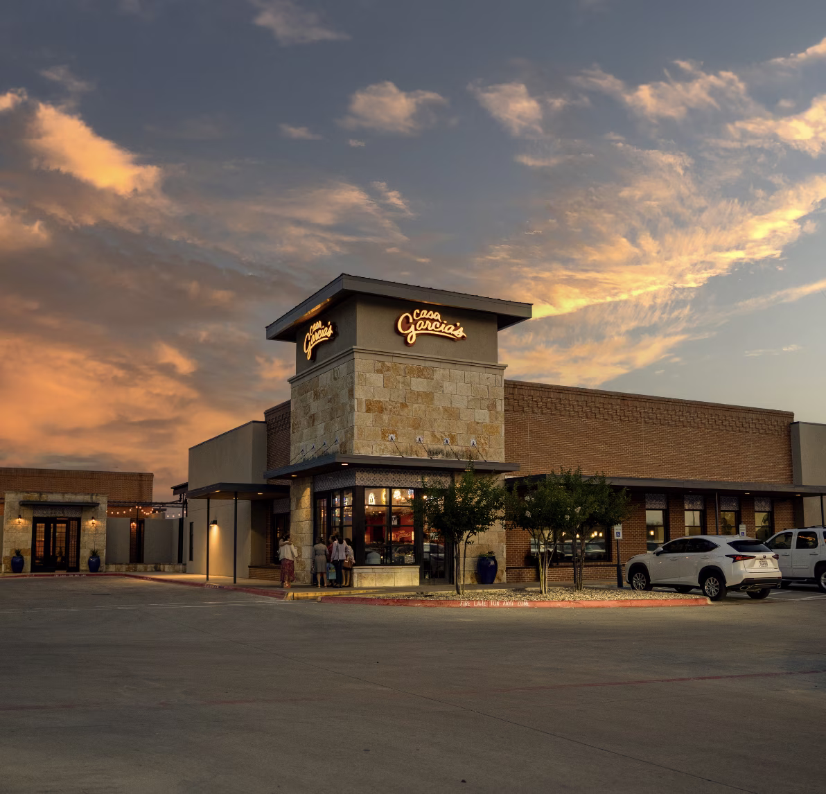 Casa Garcia's restaurant building illuminated at sunset with clouds.