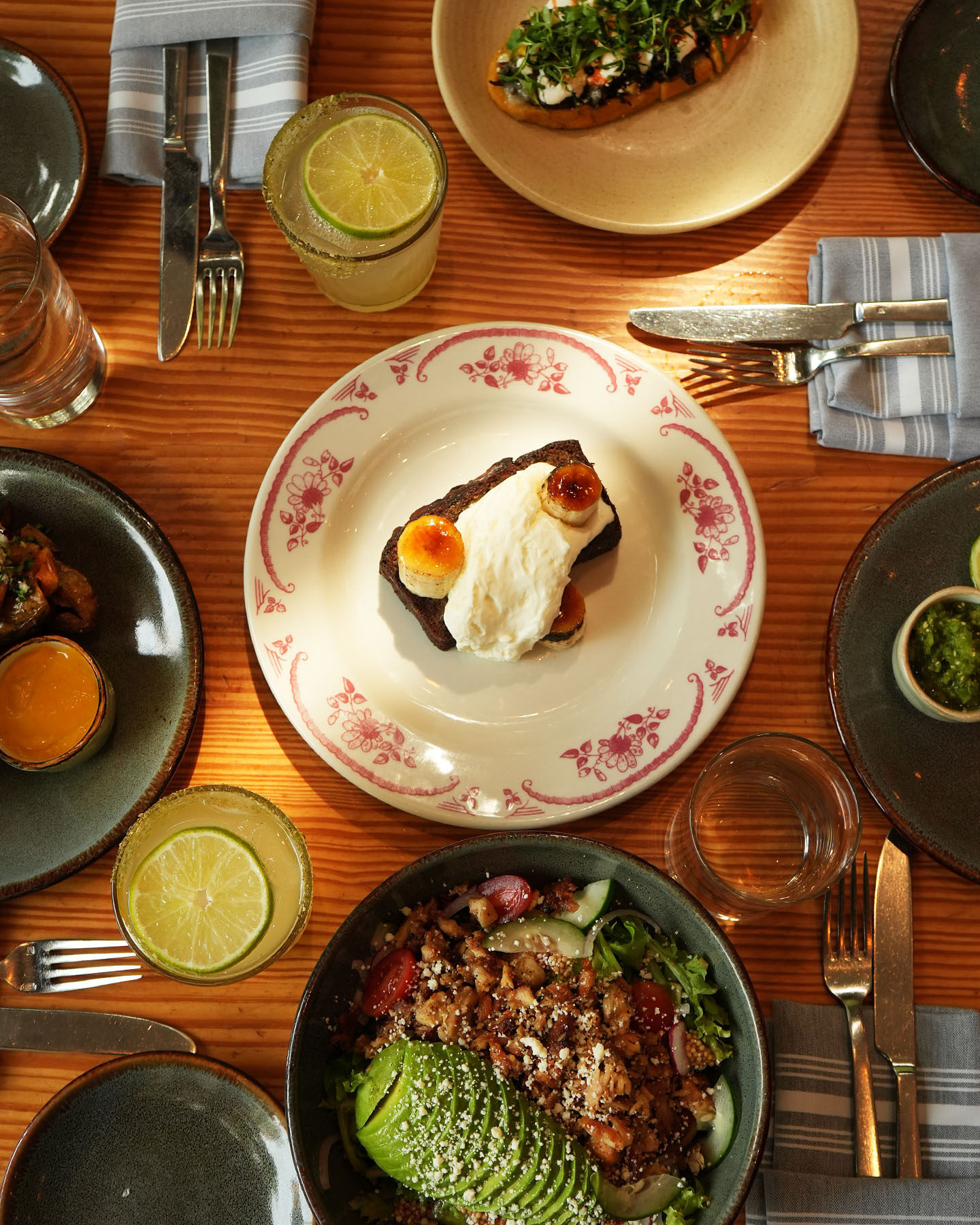 Overhead view of a dining table with multiple dishes and drinks.