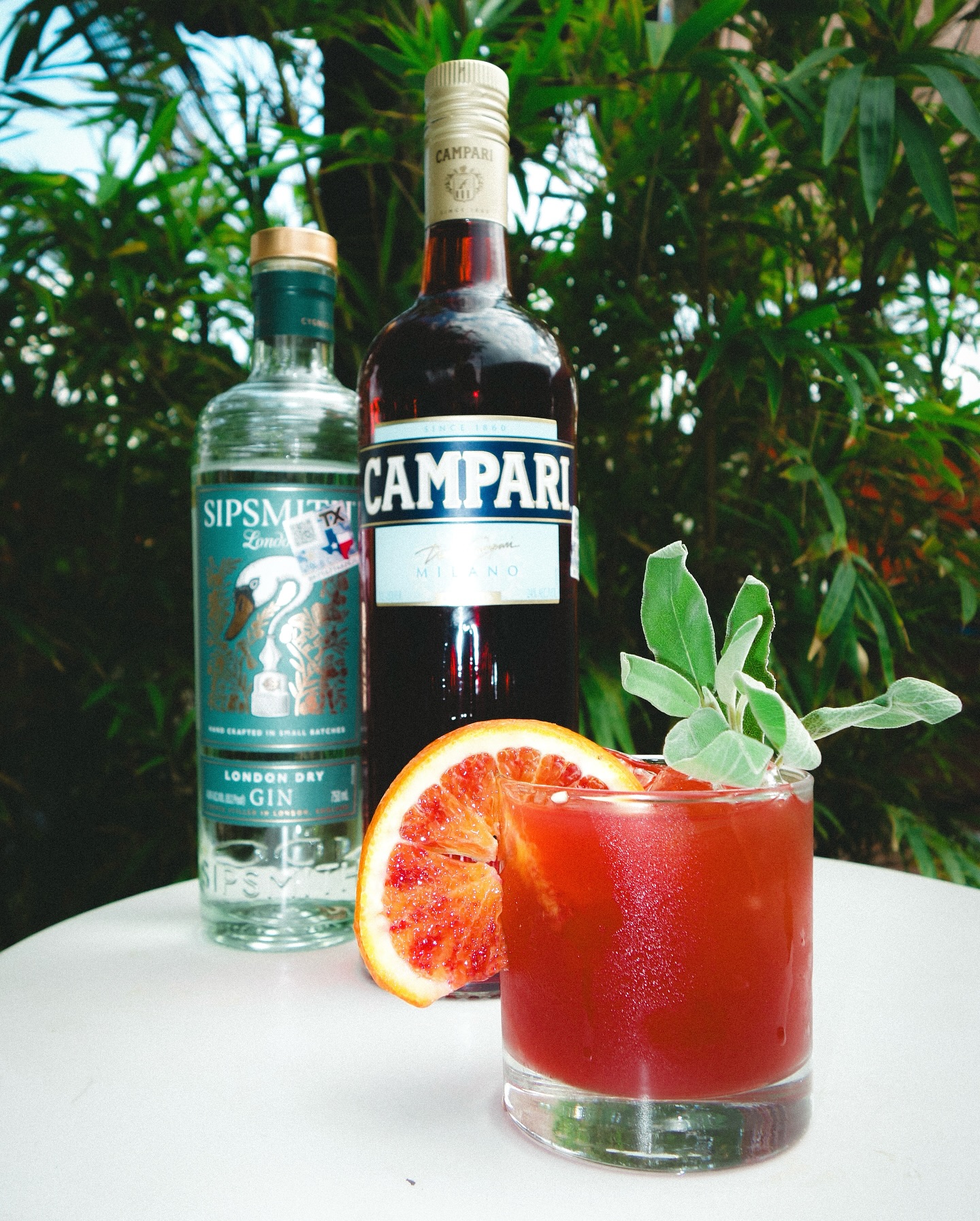 Sipsmith Gin, Campari, and a red cocktail with blood orange and herbs.